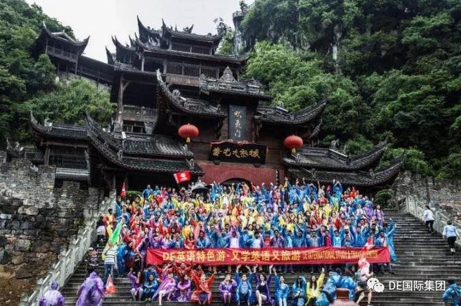 Large DE group in rain ponchos at an old town gate